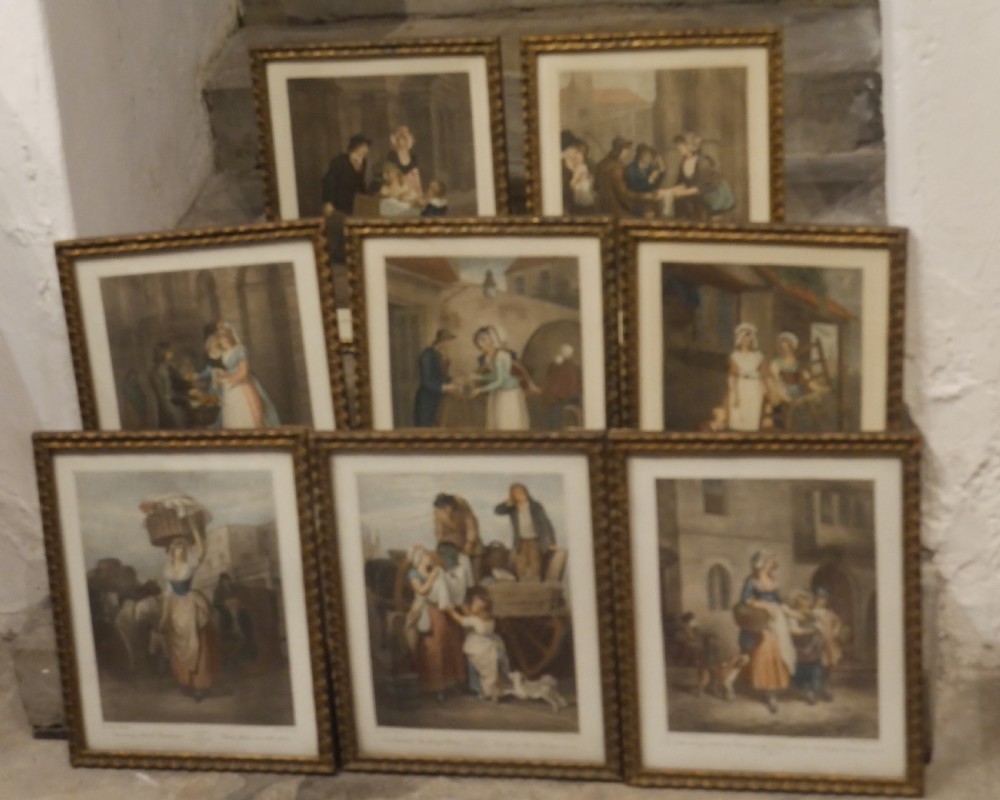 A set of eight matching framed coloured prints depicting traditional English street traders housed in gold gilt frames.
