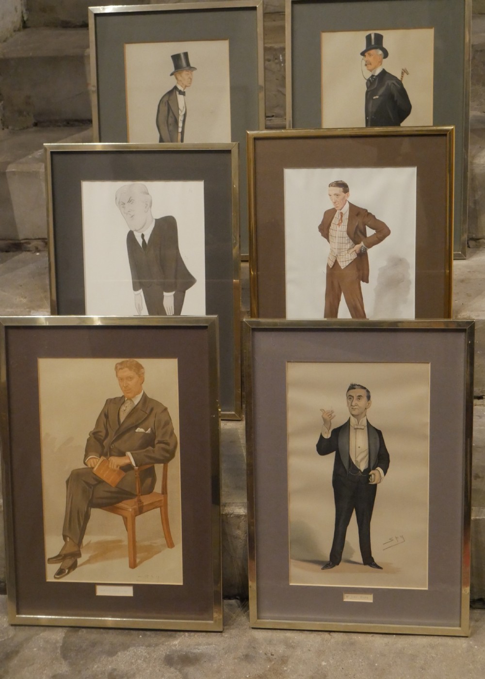 A collection of six framed antique Vanity Fair lithograph prints featuring caricatures of men in formal Victorian and Edwardian attire.