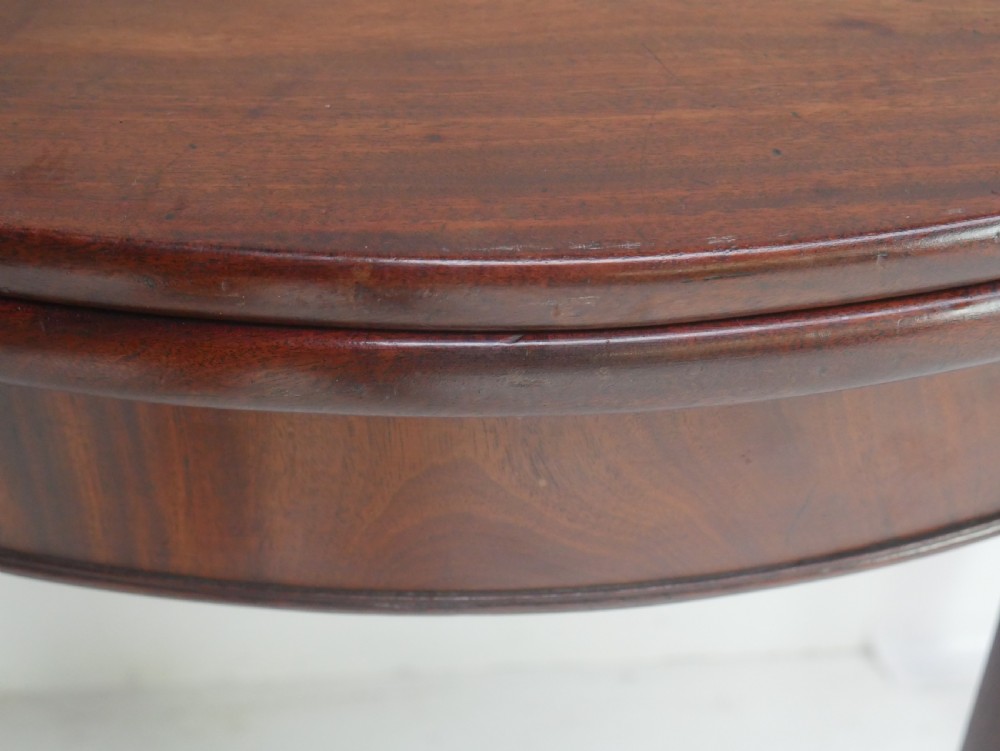 A Georgian mahogany demi-lune side table featuring a semi-circular top and four slender square tapered legs. View V