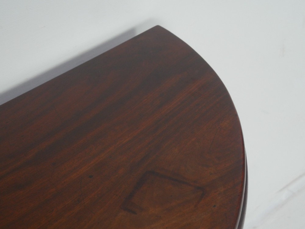A Georgian mahogany demi-lune side table featuring a semi-circular top and four slender square tapered legs. View VII