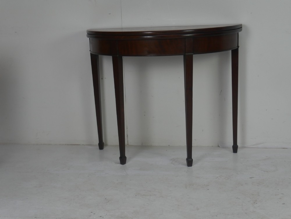 A Georgian mahogany demi-lune side table featuring a semi-circular top and four slender square tapered legs. View VIII