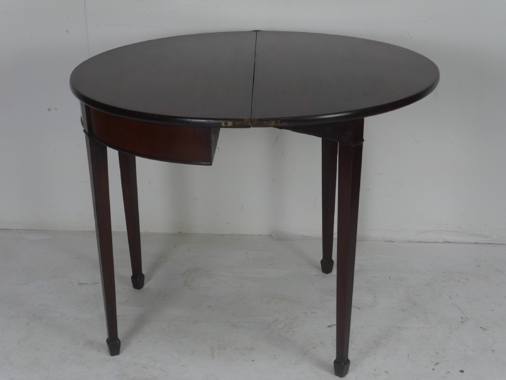 A Georgian mahogany demi-lune side table featuring a semi-circular top and four slender square tapered legs. View XI