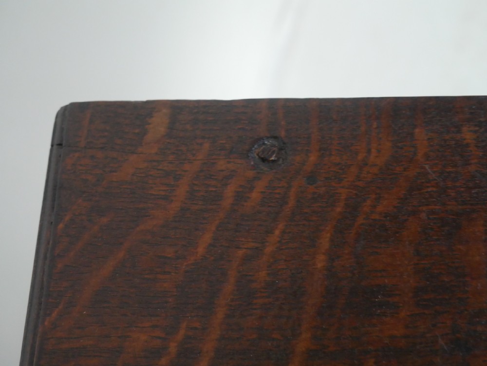 An antique dark oak side table featuring a single drawer with pierced brass handles, a shaped apron, and tapered legs ending in pad feet. View XI
