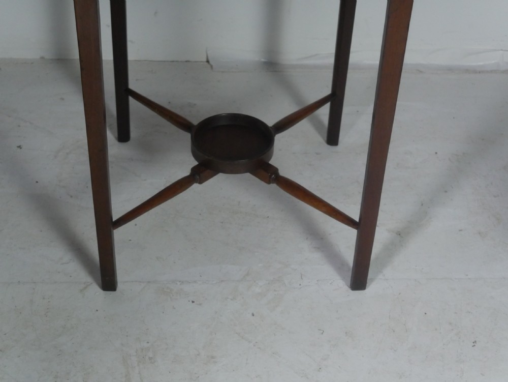 A narrow dark mahogany bedside table featuring a top surface with a gallery back, an open central shelf, a single drawer with a brass drop handle, and cross stretchers with a turned dish centre. View IV
