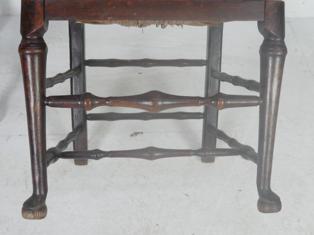 A pair of Georgian brown elm side chairs featuring spindle backrests, woven rush seats, and turned front legs. View V