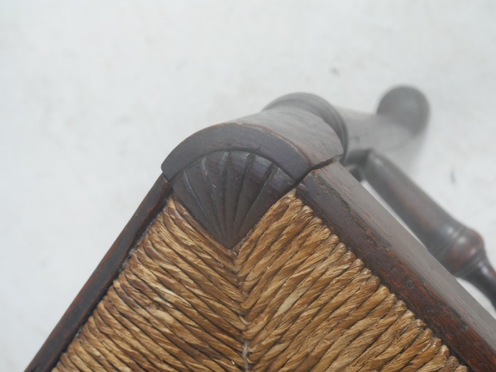 A pair of Georgian brown elm side chairs featuring spindle backrests, woven rush seats, and turned front legs. View IX