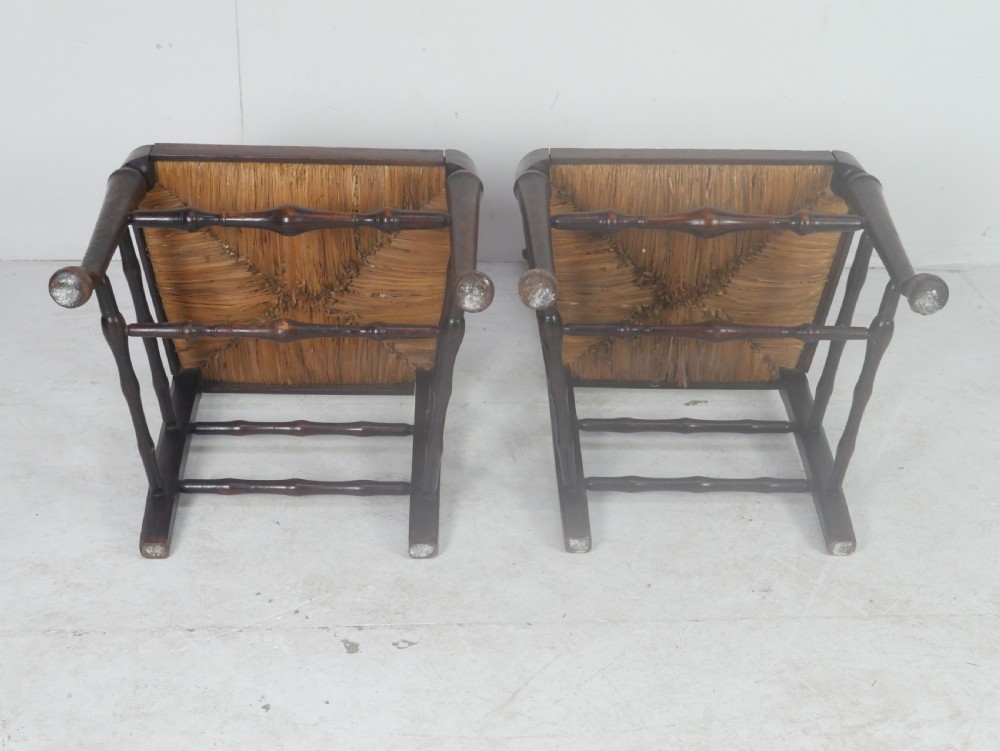 A pair of Georgian brown elm side chairs featuring spindle backrests, woven rush seats, and turned front legs. View XII