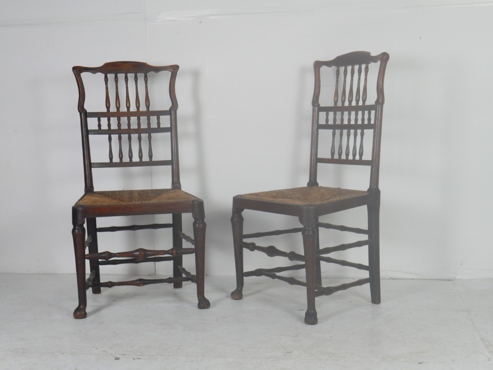 A pair of Georgian brown elm side chairs featuring spindle backrests, woven rush seats, and turned front legs. View XIII