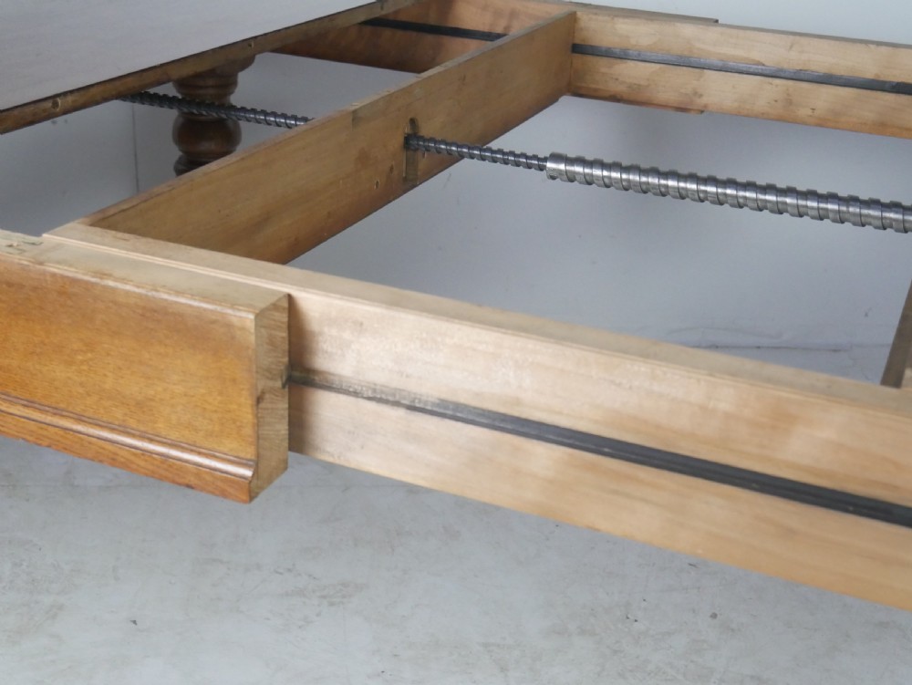Victorian mahogany extending dining table resting on four turned legs with metal castors. View V