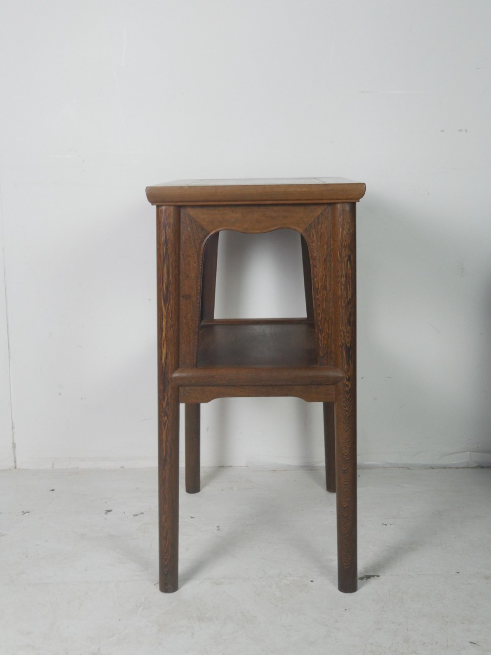 A warm brown oak side table featuring an upper rectangular top, arched aprons, a lower storage shelf, and straight legs. View IV