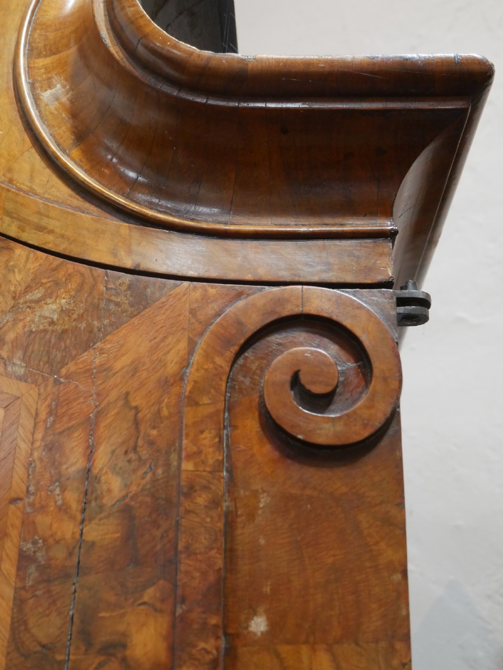 An 18th-century Dutch Rococo burr walnut cabinet featuring an arched moulded cornice, panelled doors, and a bombe three-drawer base with brass hardware. View VII