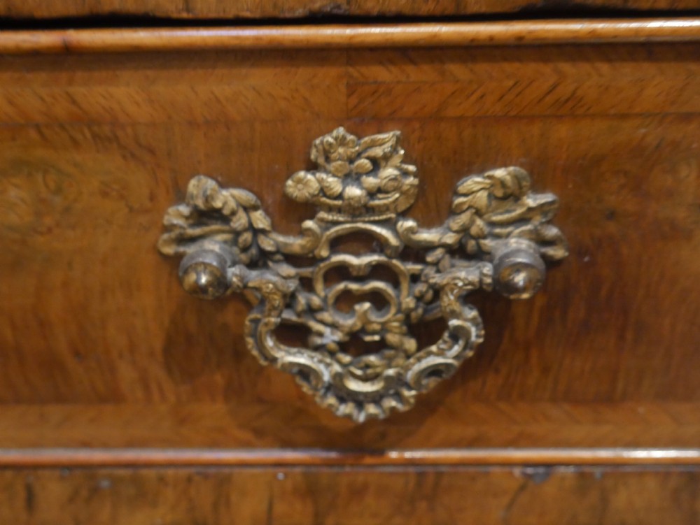 An 18th-century Dutch Rococo burr walnut cabinet featuring an arched moulded cornice, panelled doors, and a bombe three-drawer base with brass hardware. View XI