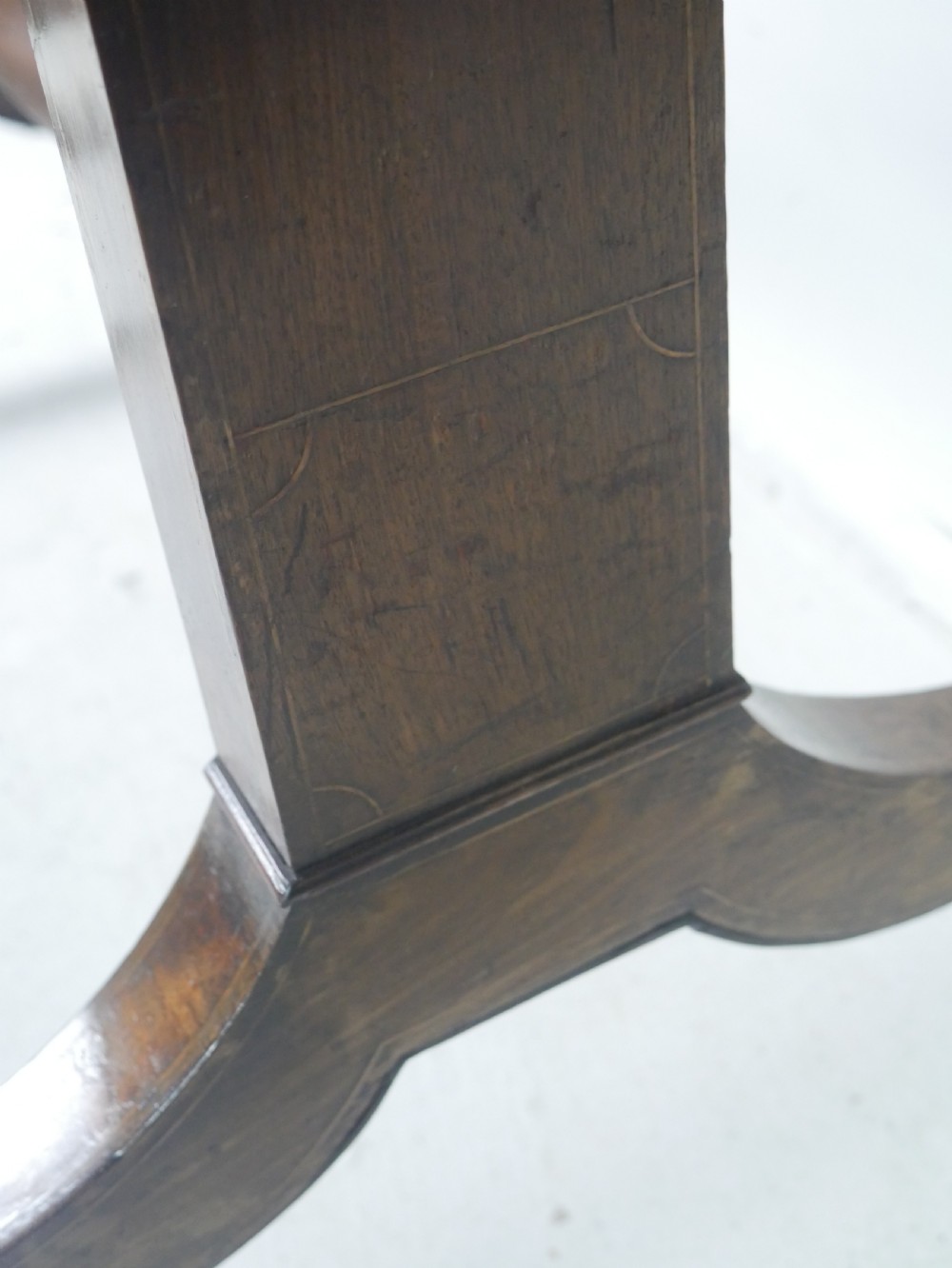 An antique Regency mahogany sofa table featuring two drop leaves, two frieze drawers with wooden knobs, and splayed legs with brass castors. View IX