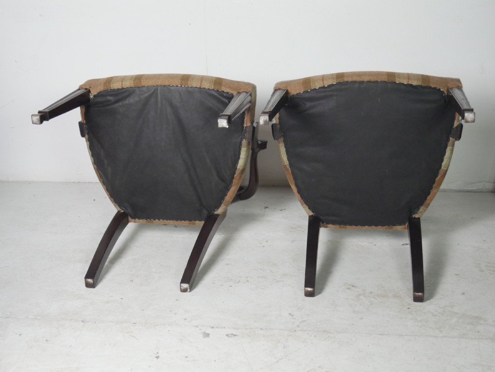 A pair of Hepplewhite style dark mahogany armchairs featuring openwork shield backs and tartan upholstered seats. View VII