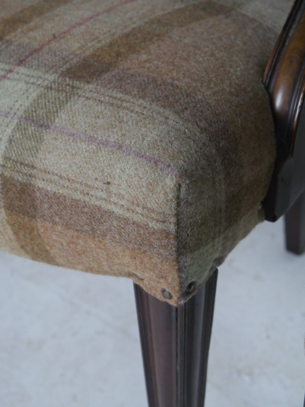 A pair of Hepplewhite style dark mahogany armchairs featuring openwork shield backs and tartan upholstered seats. View X