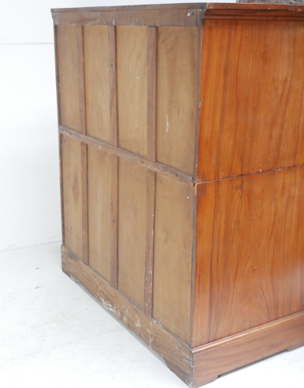A 19th-century warm brown wooden tallboy chest featuring two short drawers over three long drawers with intricate carved foliate handles. View XII