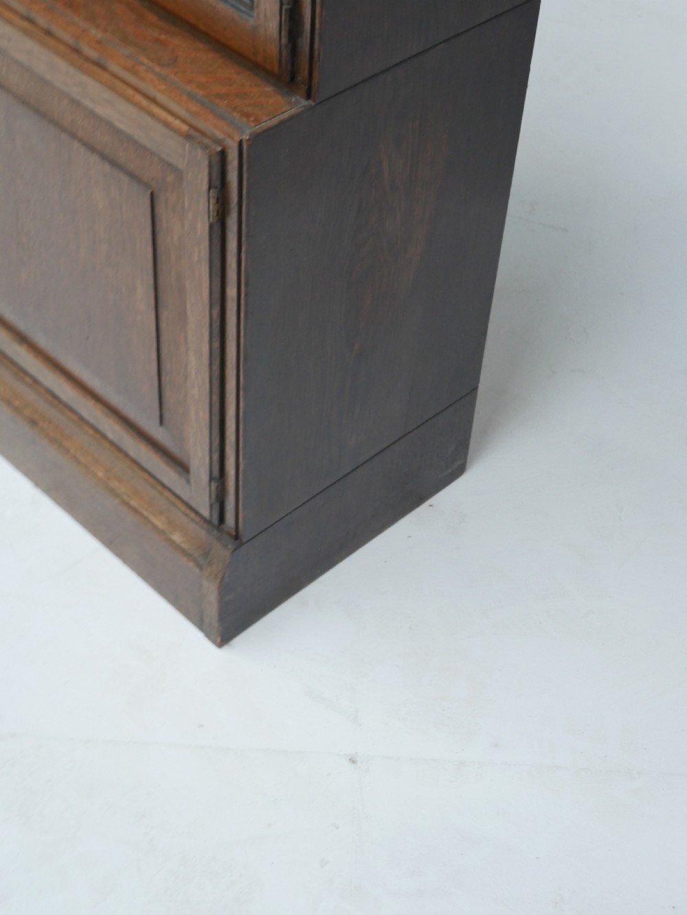 An oak stacking bookcase featuring two upper tiers with double diamond-pattern leaded glass doors above a lower cupboard with two solid panelled wooden doors. View VIII