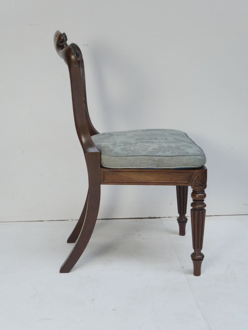 Pair of Regency mahogany side chairs with blue fabric seats and turned reeded legs. View II