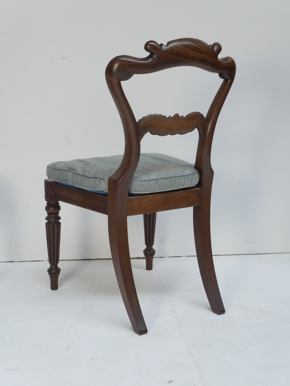 Pair of Regency mahogany side chairs with blue fabric seats and turned reeded legs. View IV