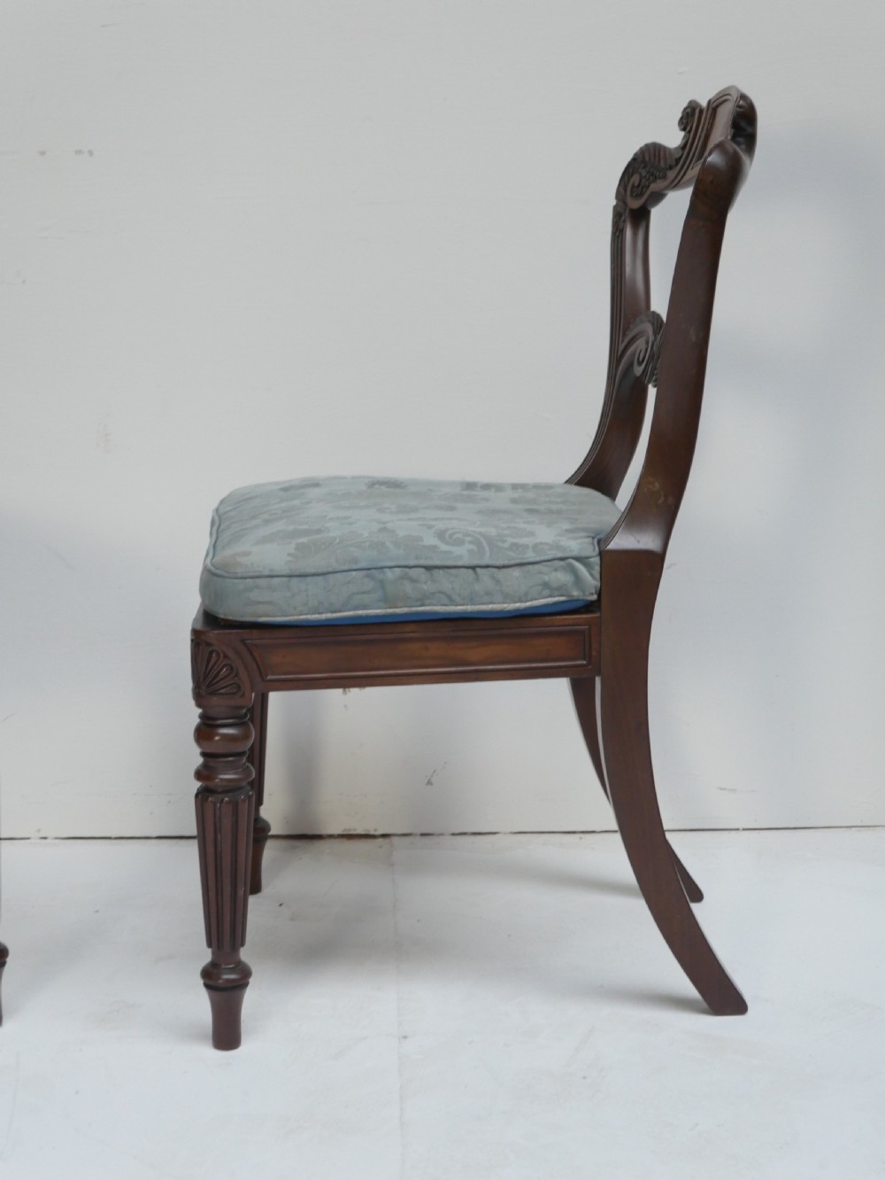 Pair of Regency mahogany side chairs with blue fabric seats and turned reeded legs. View V