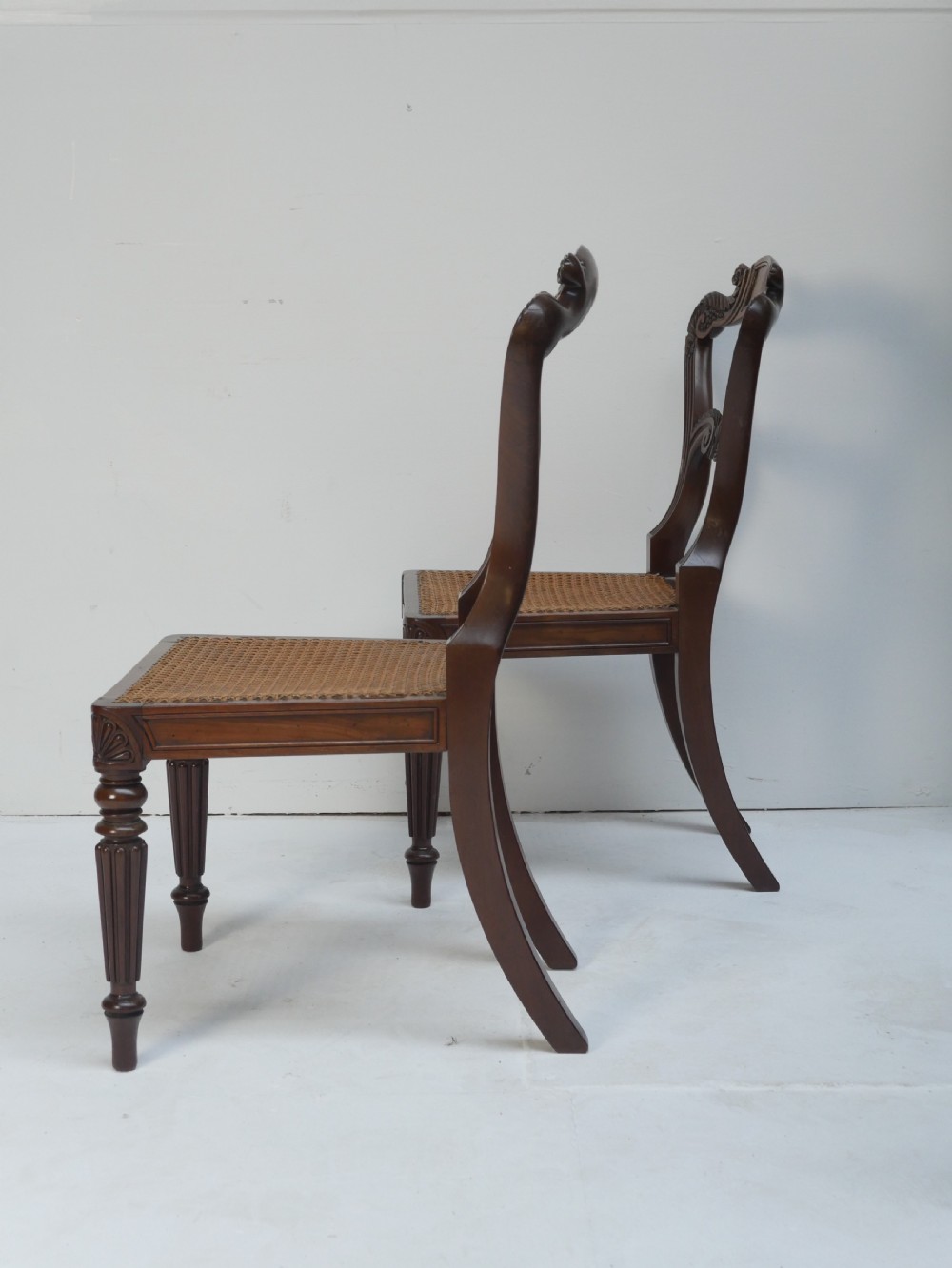Pair of Regency mahogany side chairs with blue fabric seats and turned reeded legs. View IX