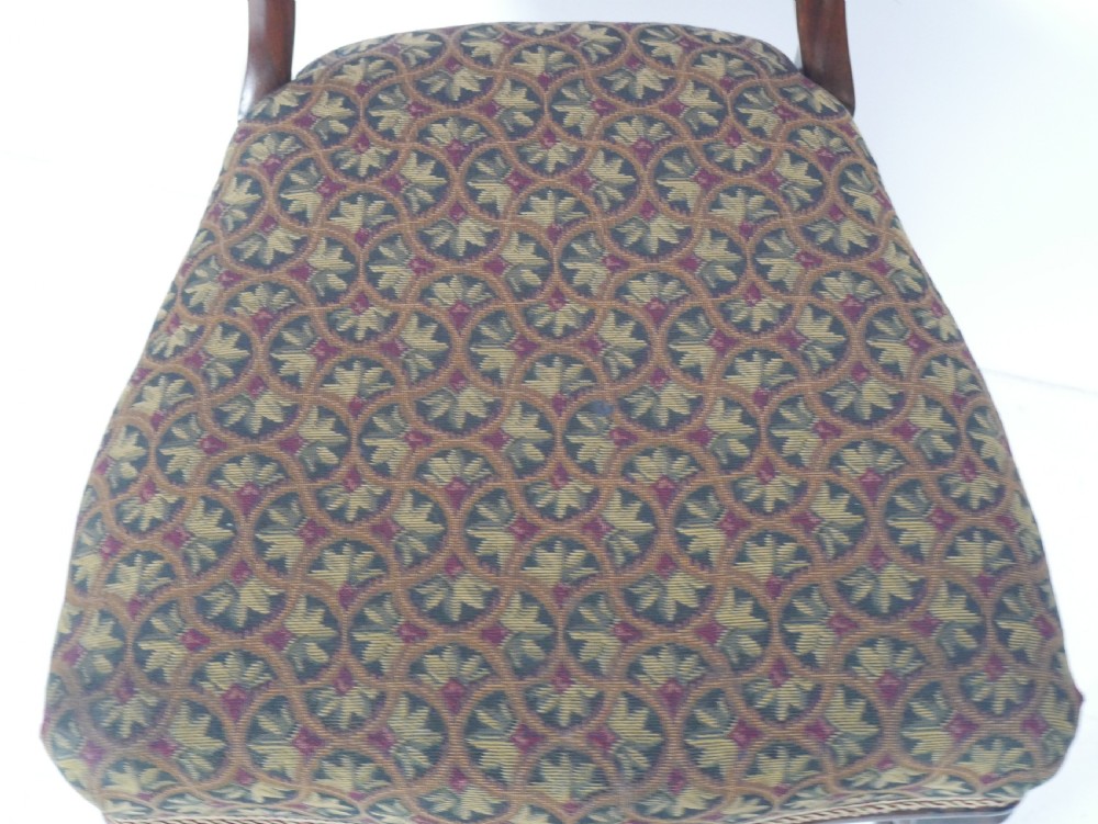 A pair of Victorian rosewood balloon back side chairs featuring turned front legs and patterned upholstered seats. View IV