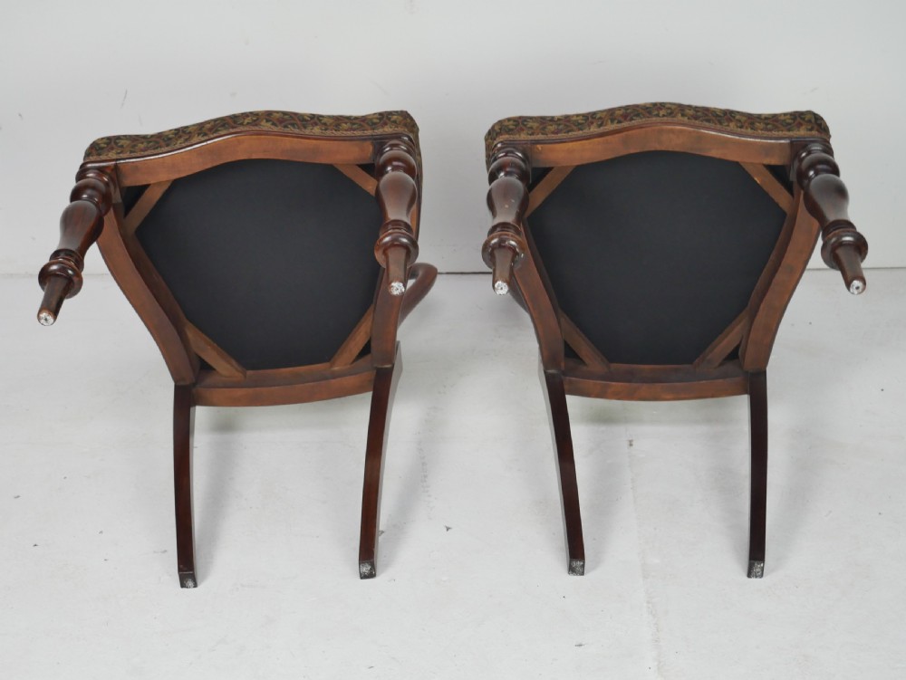 A pair of Victorian rosewood balloon back side chairs featuring turned front legs and patterned upholstered seats. View VI