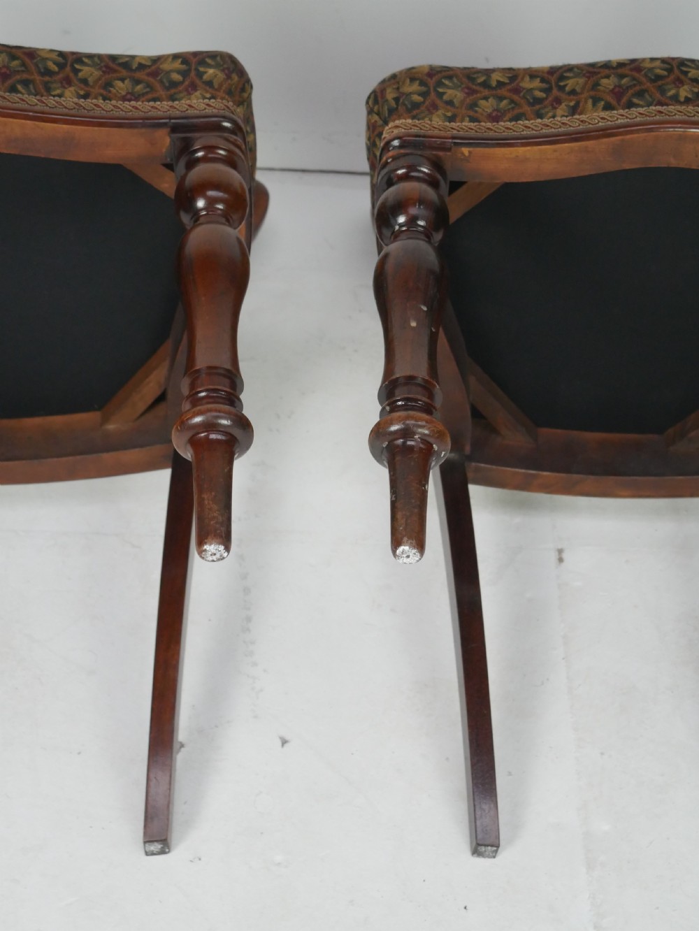 A pair of Victorian rosewood balloon back side chairs featuring turned front legs and patterned upholstered seats. View VII