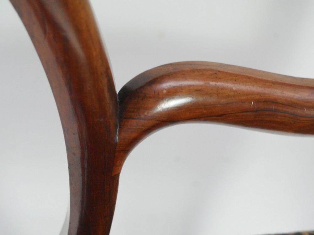 A pair of Victorian rosewood balloon back side chairs featuring turned front legs and patterned upholstered seats. View VIII