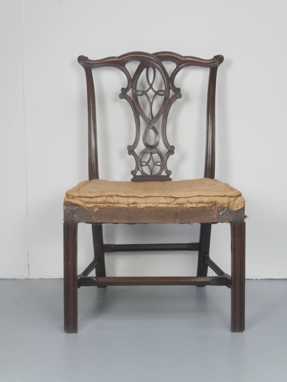 A set of eight dark mahogany Georgian style dining chairs featuring carved pierced splats and patterned fabric drop-in seats, comprising six side chairs and two carver armchairs. View II