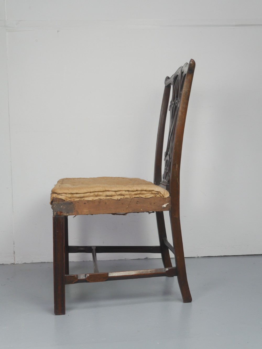A set of eight dark mahogany Georgian style dining chairs featuring carved pierced splats and patterned fabric drop-in seats, comprising six side chairs and two carver armchairs. View XI
