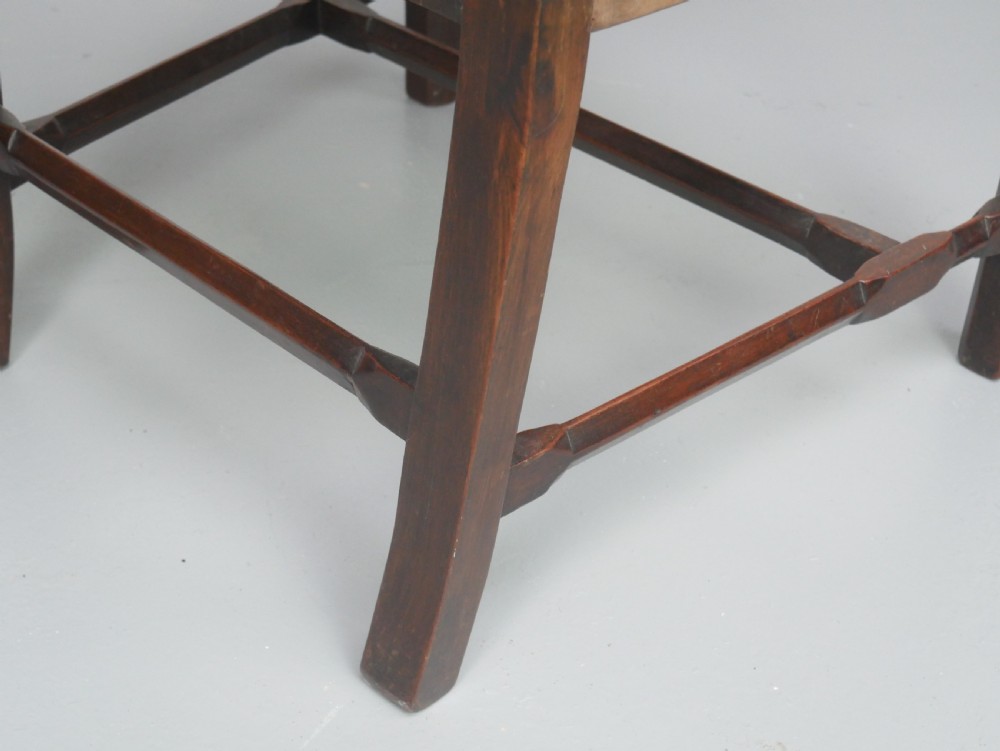 A set of eight dark mahogany Georgian style dining chairs featuring carved pierced splats and patterned fabric drop-in seats, comprising six side chairs and two carver armchairs. View XIX