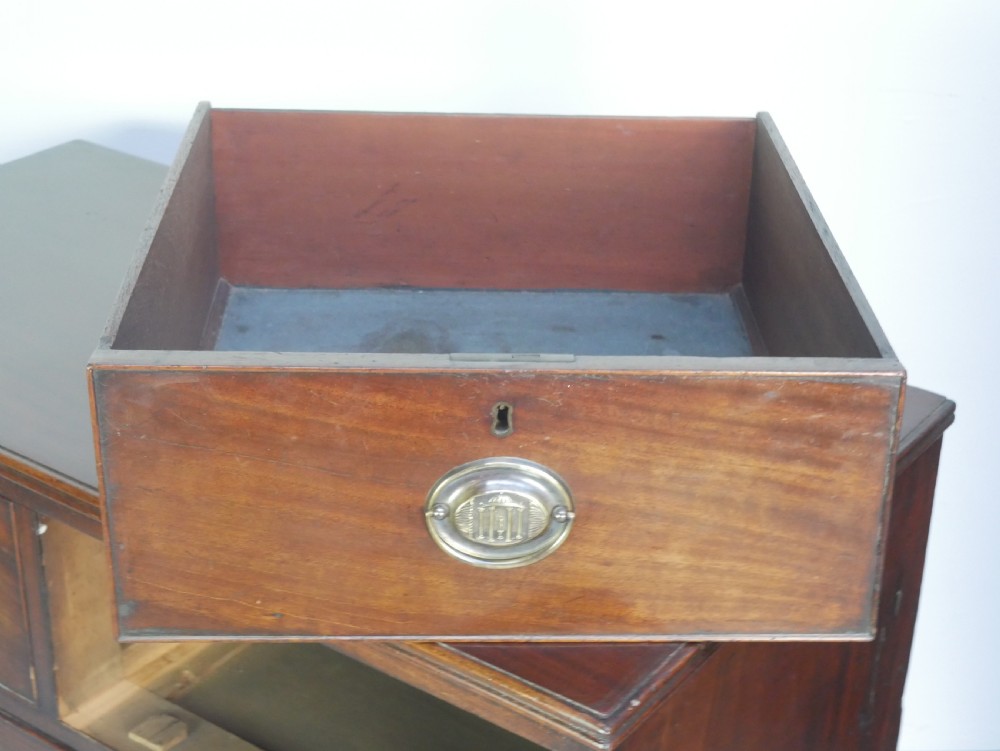 A Georgian mahogany chest of drawers featuring two short over two long graduated drawers with round brass handles and bracket feet. View VI
