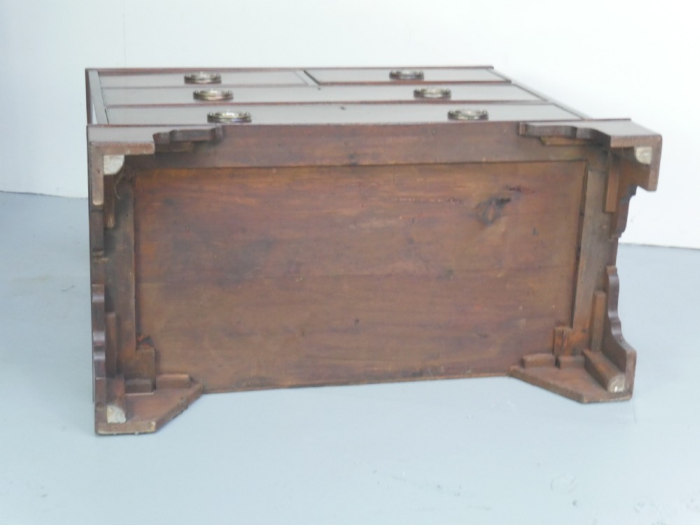 A Georgian mahogany chest of drawers featuring two short over two long graduated drawers with round brass handles and bracket feet. View VIII