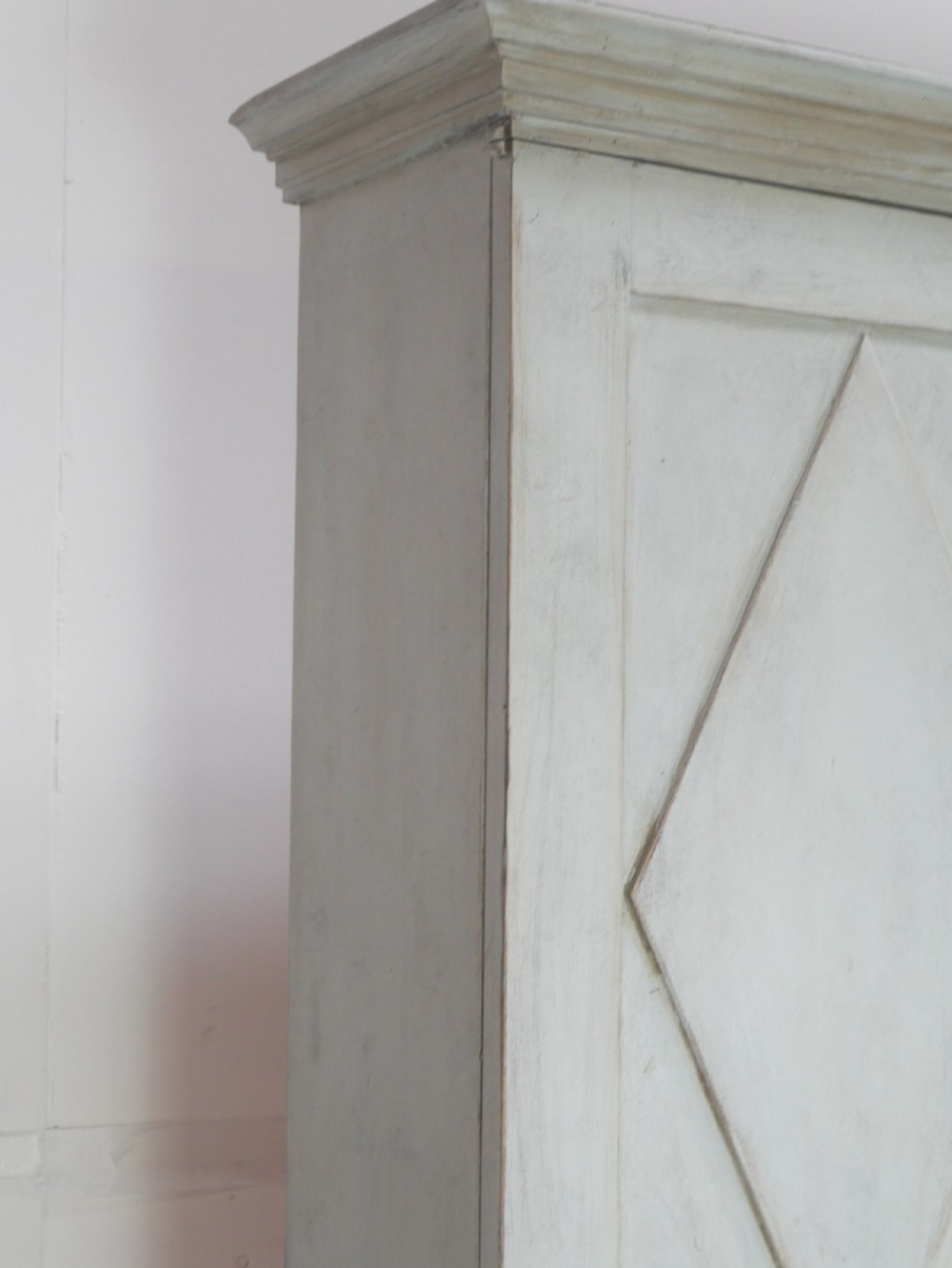 A tall two-tier Swedish softwood bureau cabinet with diamond panel moulding on the doors, a slanted fall-front flap, and a distressed pale grey painted finish. View V