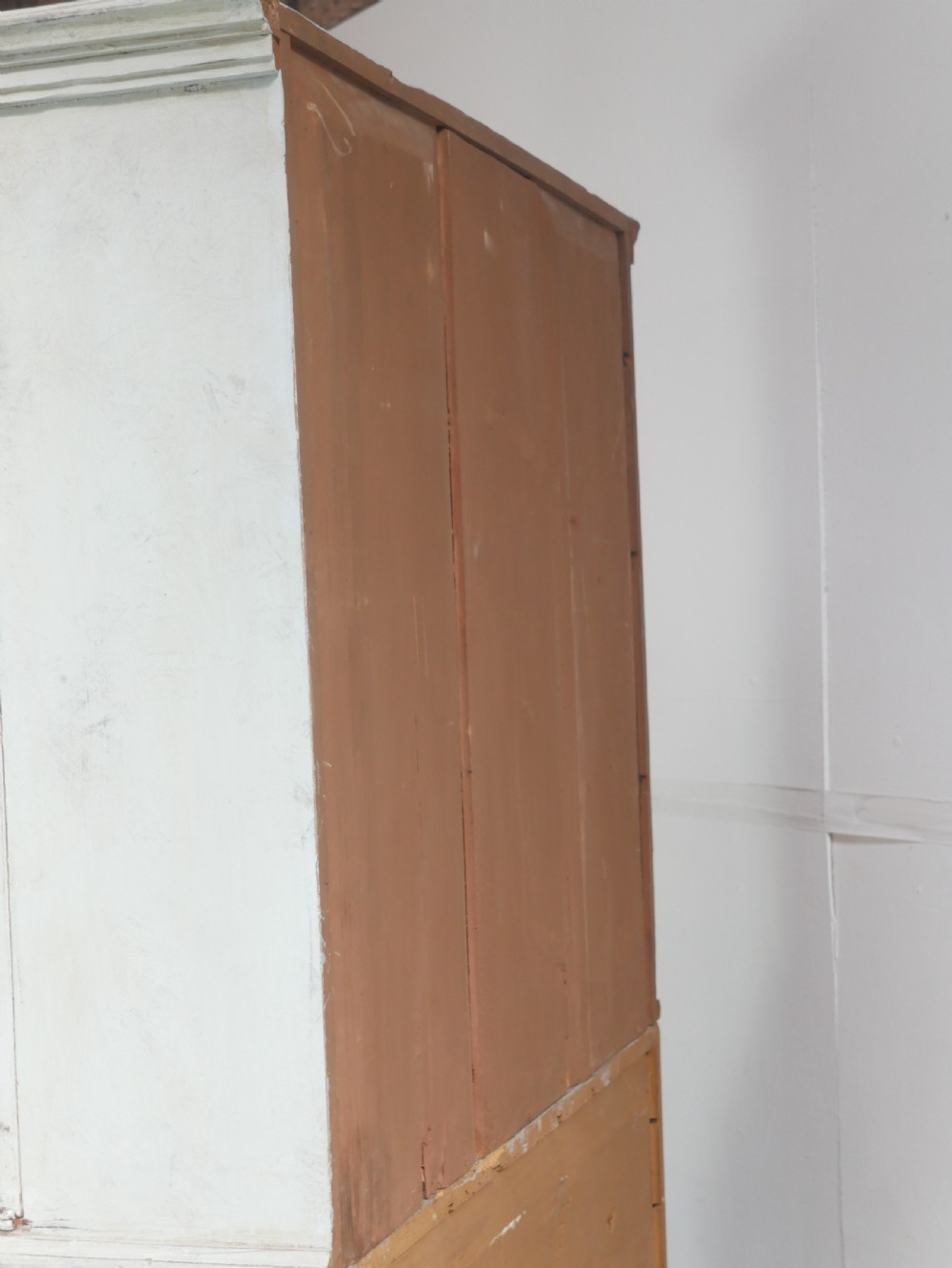 A tall two-tier Swedish softwood bureau cabinet with diamond panel moulding on the doors, a slanted fall-front flap, and a distressed pale grey painted finish. View XIV