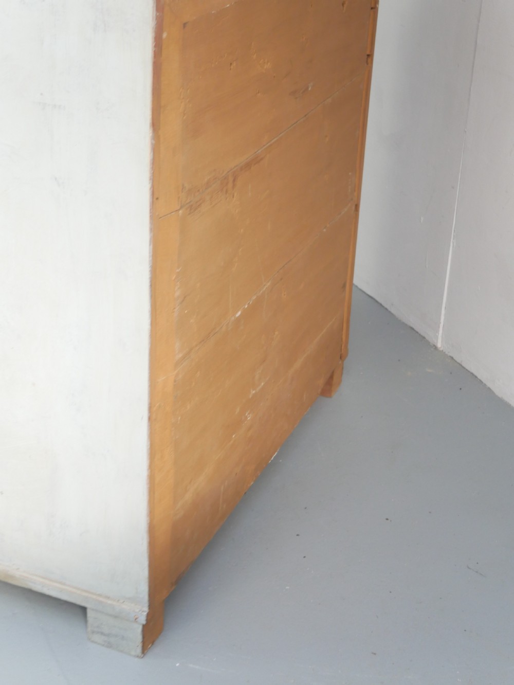 A tall two-tier Swedish softwood bureau cabinet with diamond panel moulding on the doors, a slanted fall-front flap, and a distressed pale grey painted finish. View XV