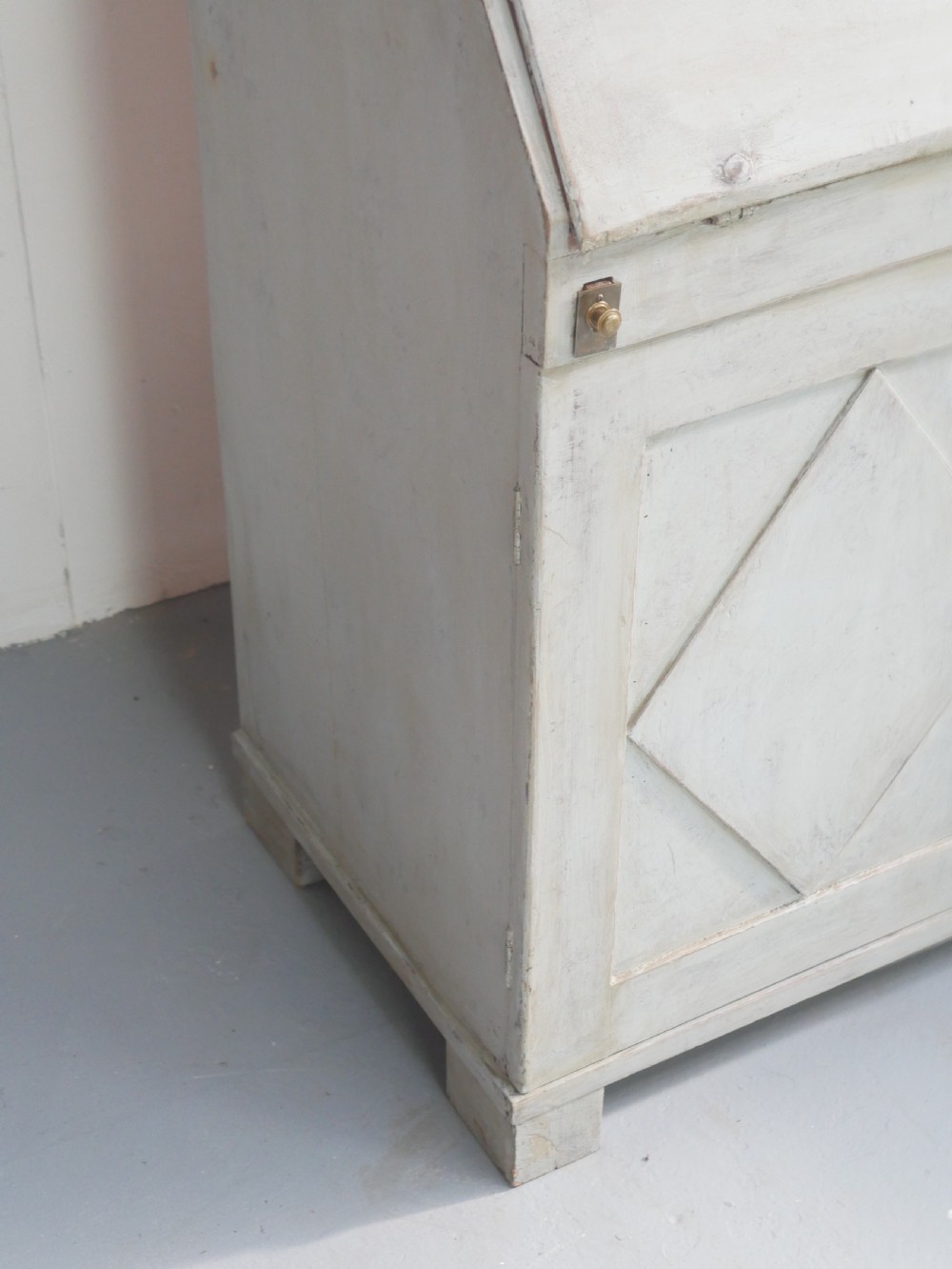 A tall two-tier Swedish softwood bureau cabinet with diamond panel moulding on the doors, a slanted fall-front flap, and a distressed pale grey painted finish. View XVIII