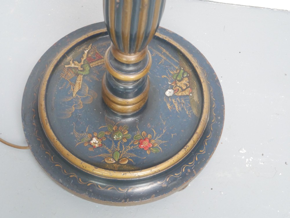 A tall turned wooden standard lamp painted dark blue with hand-painted gilt Chinoiserie botanical motifs and a circular base. View II