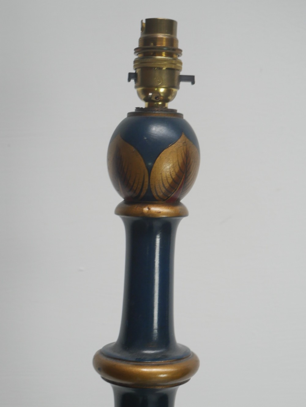 A tall turned wooden standard lamp painted dark blue with hand-painted gilt Chinoiserie botanical motifs and a circular base. View VII