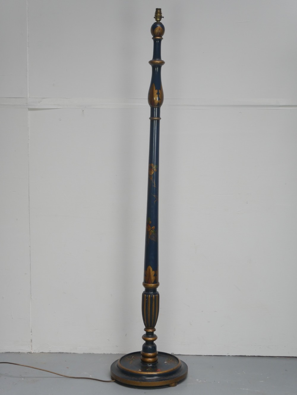 A tall turned wooden standard lamp painted dark blue with hand-painted gilt Chinoiserie botanical motifs and a circular base. View XII