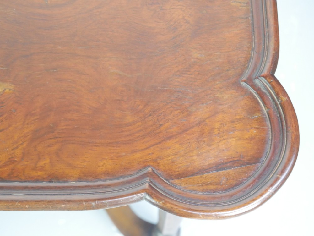 A matching pair of polished warm brown mahogany side tables featuring raised tray-top edges, turned legs, and curved X-stretchers. View III
