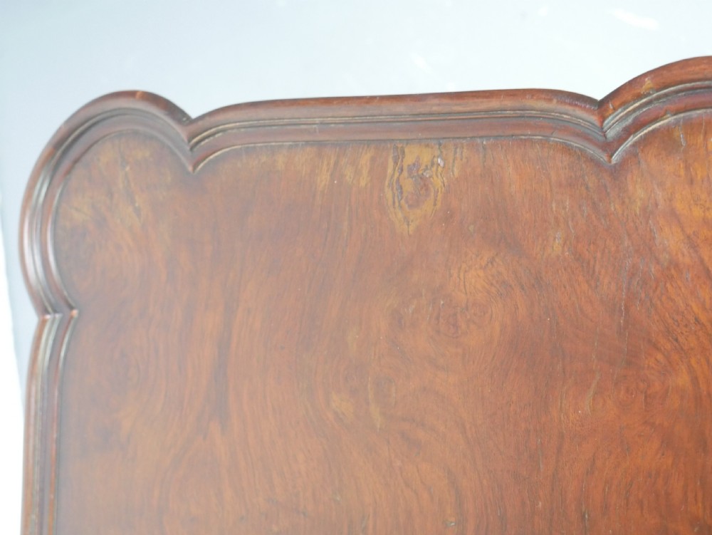 A matching pair of polished warm brown mahogany side tables featuring raised tray-top edges, turned legs, and curved X-stretchers. View IV