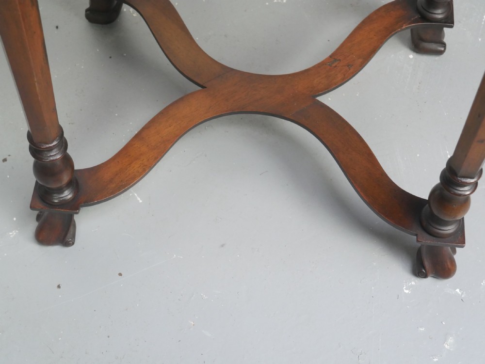 A matching pair of polished warm brown mahogany side tables featuring raised tray-top edges, turned legs, and curved X-stretchers. View VII