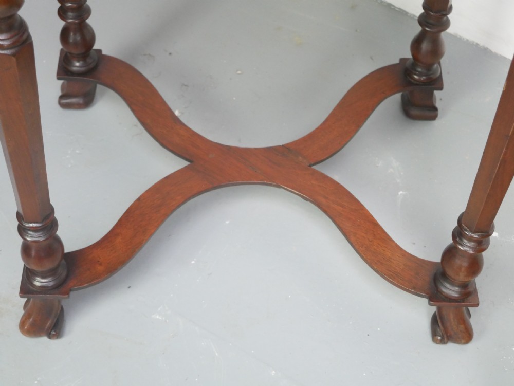 A matching pair of polished warm brown mahogany side tables featuring raised tray-top edges, turned legs, and curved X-stretchers. View VIII