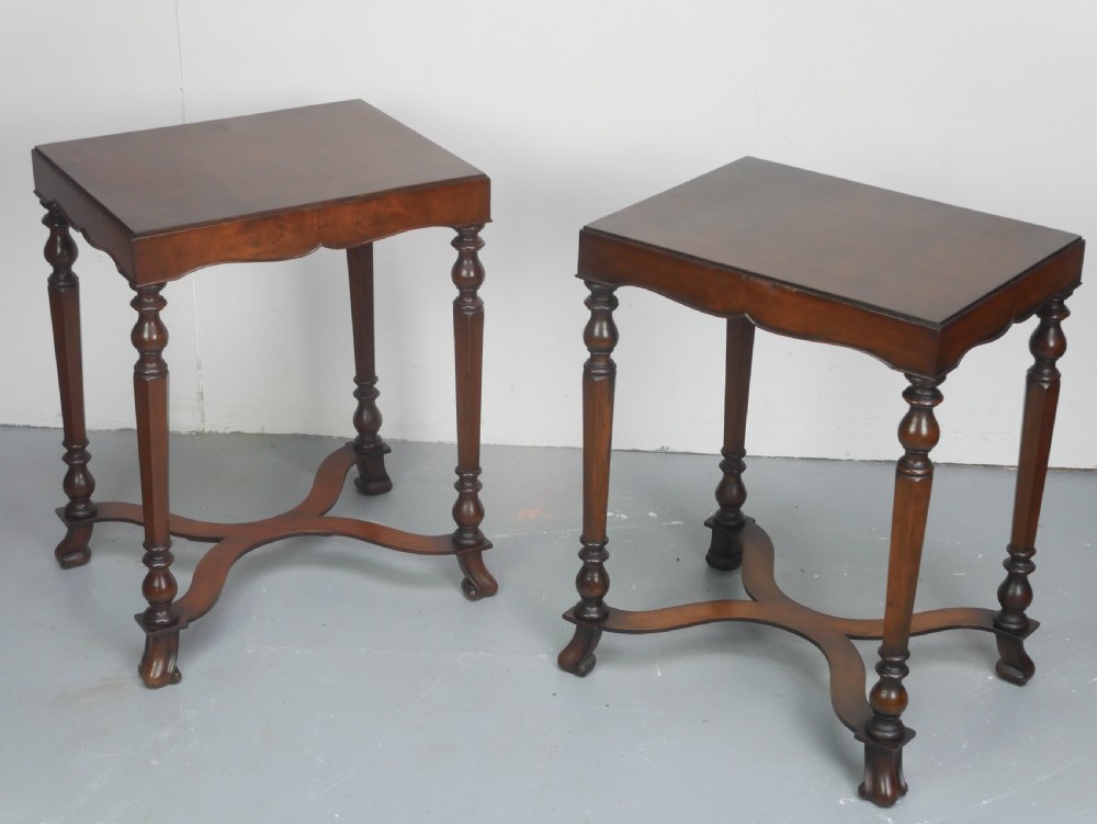 A matching pair of polished warm brown mahogany side tables featuring raised tray-top edges, turned legs, and curved X-stretchers. View XII