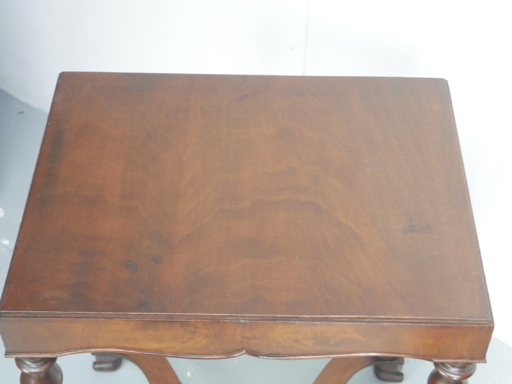 A matching pair of polished warm brown mahogany side tables featuring raised tray-top edges, turned legs, and curved X-stretchers. View XIII