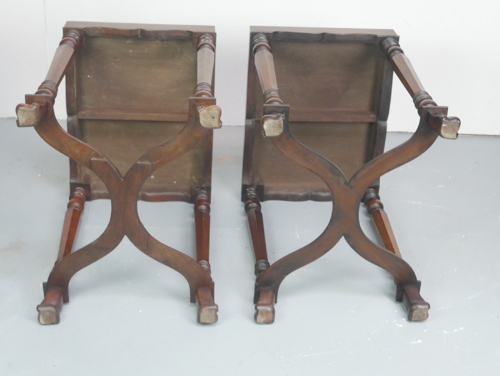 A matching pair of polished warm brown mahogany side tables featuring raised tray-top edges, turned legs, and curved X-stretchers. View XVI