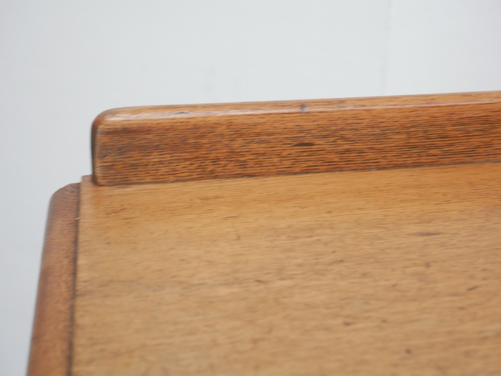 An antique burr ash chest of drawers featuring two short over three long graduated drawers with turned wooden knobs and bracket feet. View VI