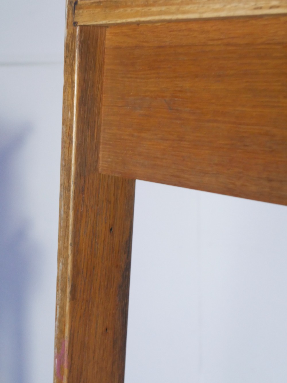 A tall freestanding oak library step ladder featuring multiple wide treads, shaped handholds at the top, and a warm natural wood finish. View X